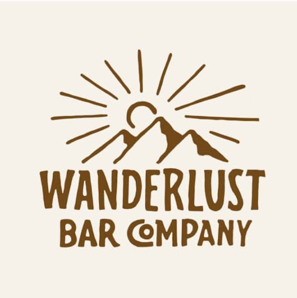 Logo design with the sun behind a mountain for brand: 'Wanderlust Bar Company'